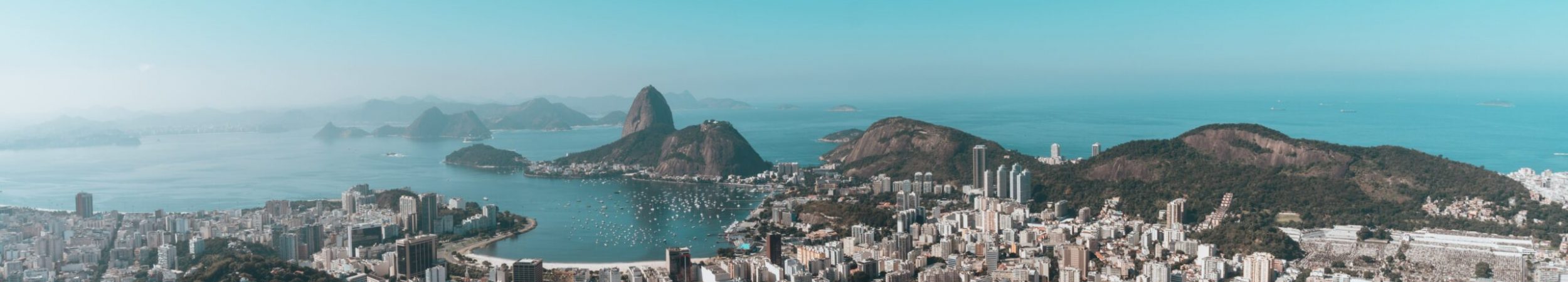 Landscape of Rio De Janeiro surrounded by the sea under a blue sky in Brazil A landscape of Rio De Janeiro surrounded by the sea under a blue sky in Brazil